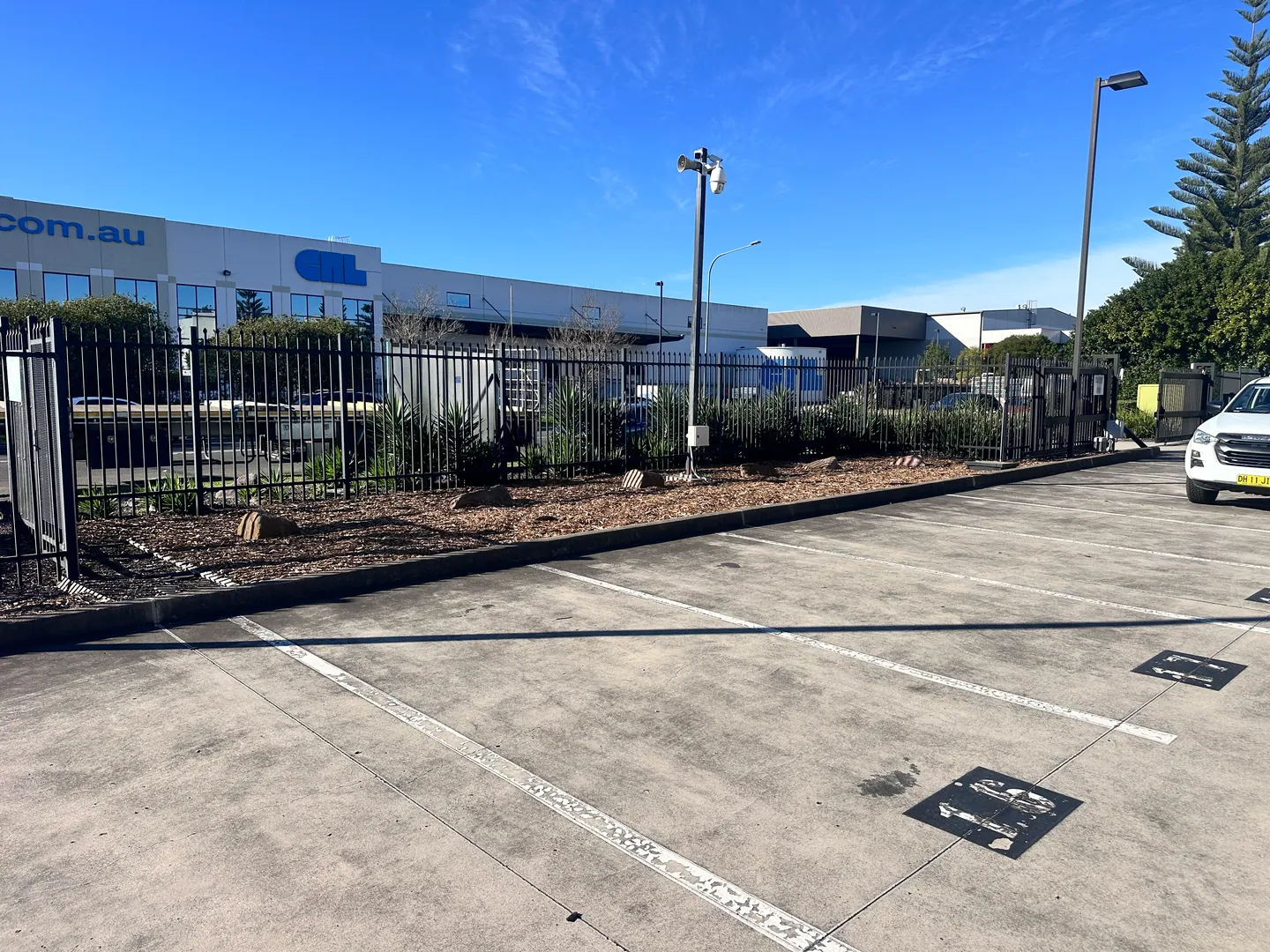 Maintained planting and fencing along the frontage of a commercial property