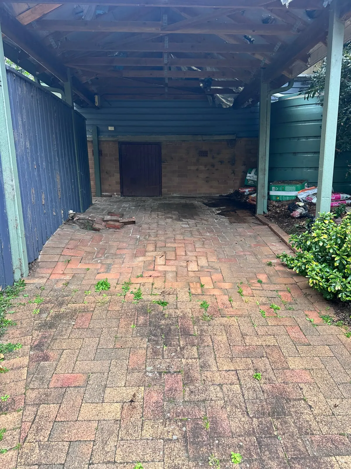 Uneven brick paving under the Epping carport before repair