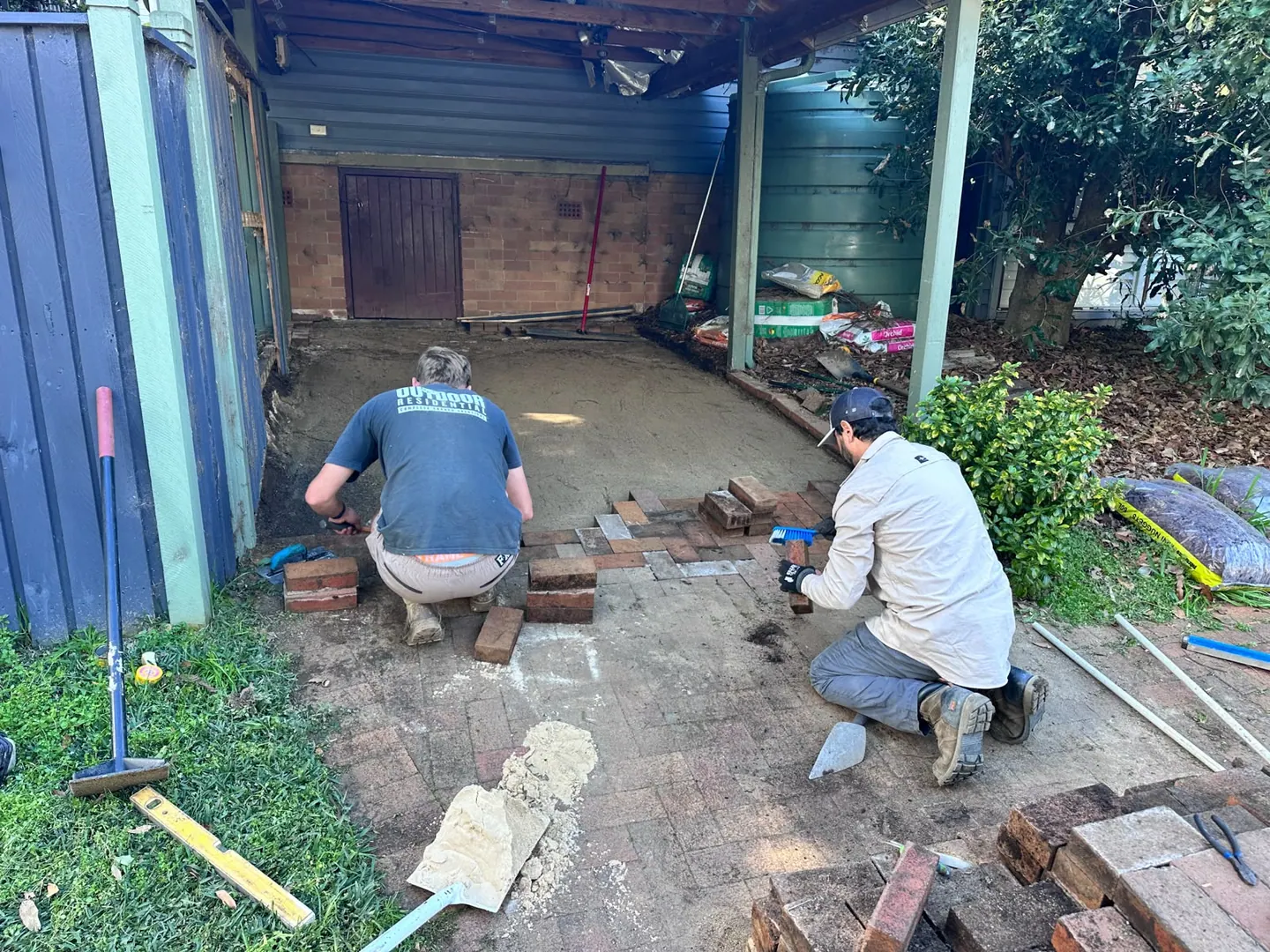 Pete and the team relaying the original pavers on the levelled base