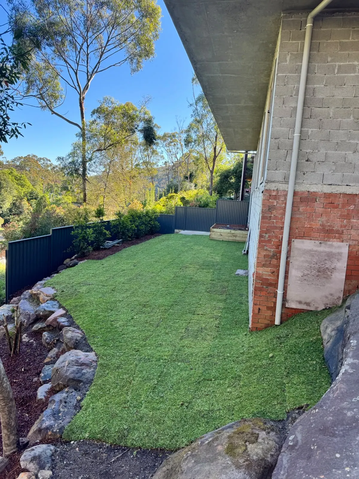 Neatly presented turf and garden edging alongside a home